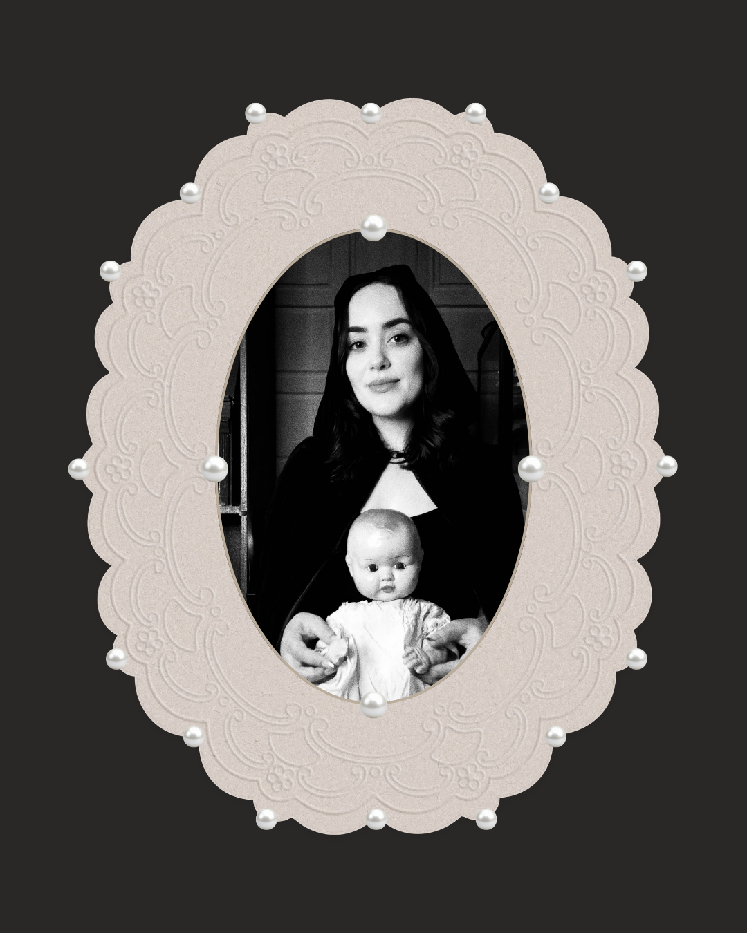 An ornate oval cream-colored photo frame with scalloped edges and pearl-like beads, holding a black-and-white portrait of a woman holding a baby, set against a dark gray background.